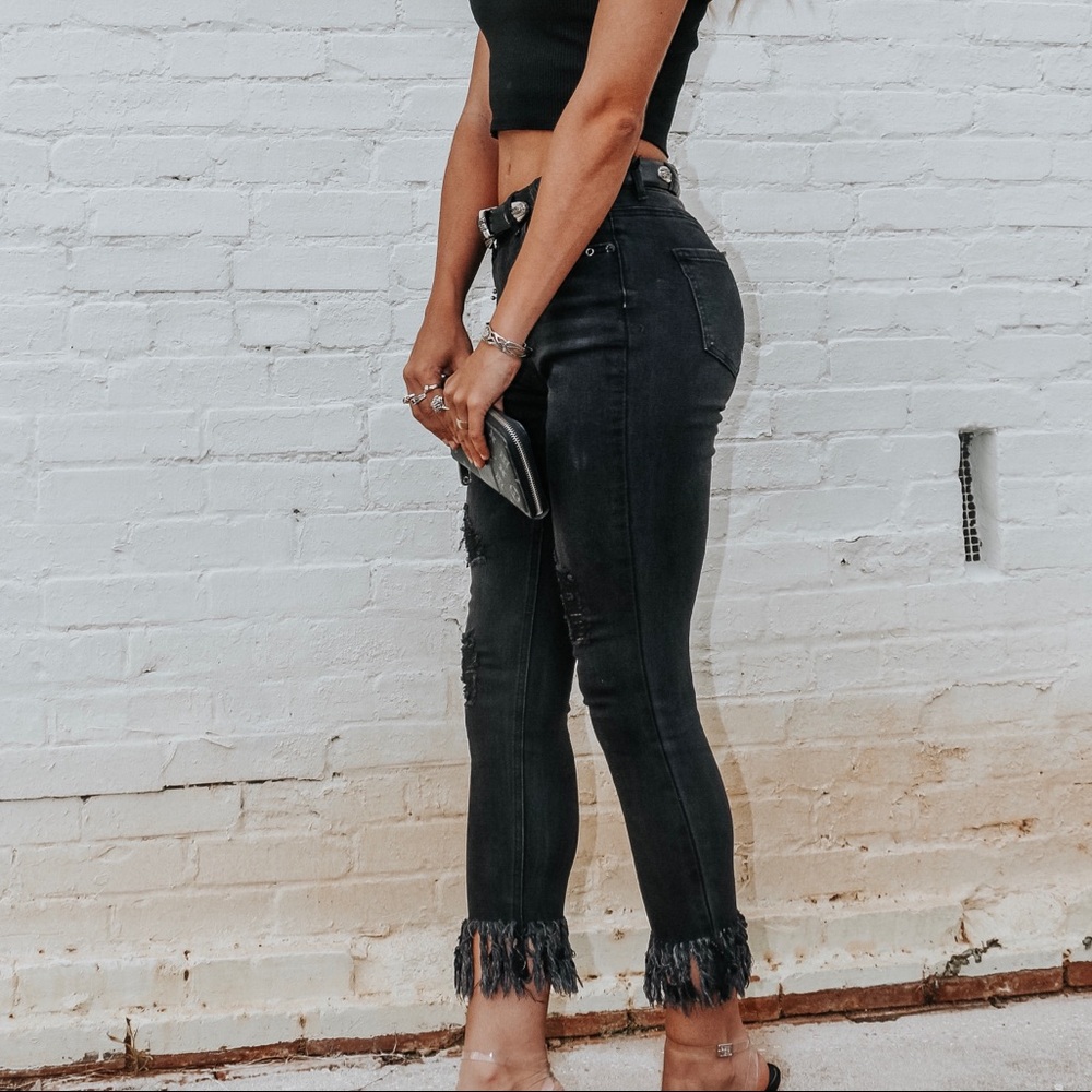 Black fringe bottom denim jeans with metal details